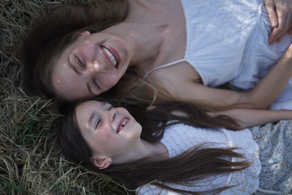Family portrait outdoors, landscape framing with natural light