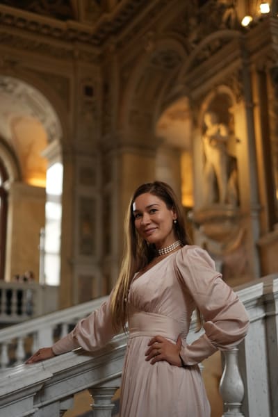 Smiling portrait on a baroque staircase with marble balustrade and gilded statues