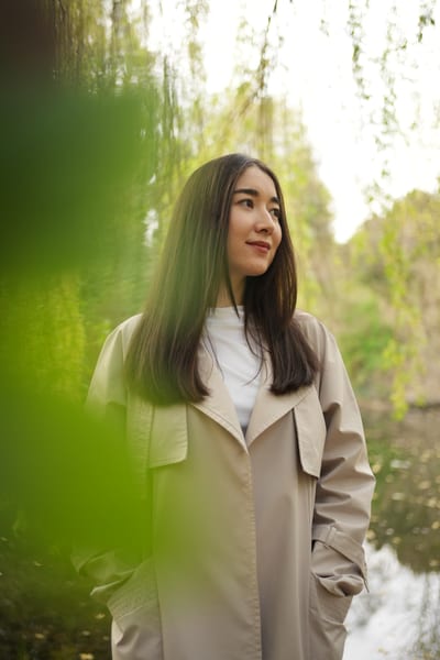 Woman in white shirt touching delicate white flowering spring branches